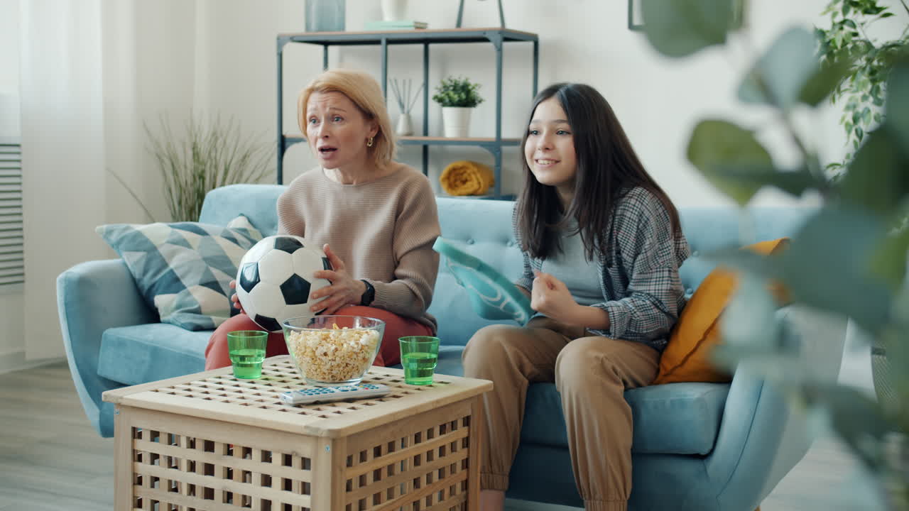 Mother and daughter watching a soccer game