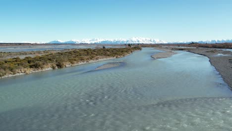 flying low across beautiful rakaia river to show interesting patterns from side-channels