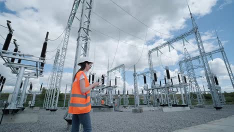 an engineering employee makes a tour and inspection of a modern electrical substation. energy.