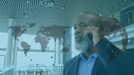 animation of world map over african american businessman with smartphone