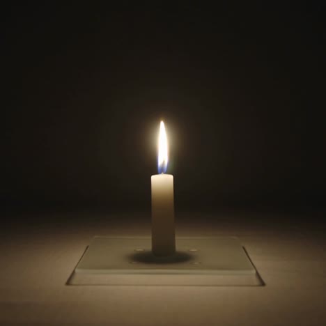 Timelapse-of-a-small-candle-burning-in-a-dark-room