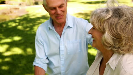 Retired-man-walking-with-his-wife-using-a-walker