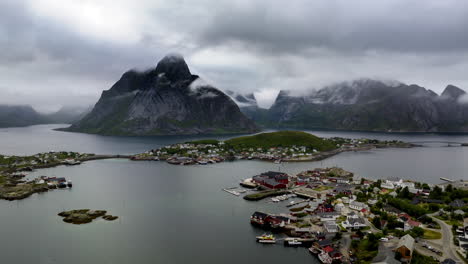 drone hyperlapse view of moody clouds around mountains next to reine, lofoten