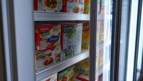 frozen food section in a supermarket freezer