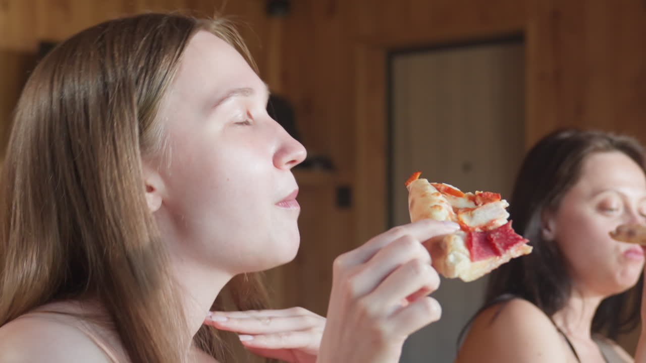 Young woman enjoying a slice of pepperoni pizza while dancing to music in the background, captured in a joyful and carefree moment, savoring the pizza and feeling the rhythm