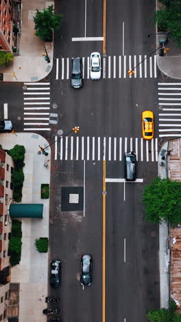 descending above one of the crossroads in new york. drone footage along the orange brick multistoried buildings.
