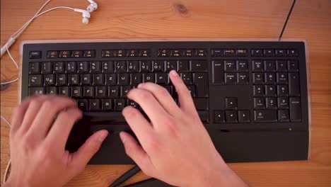 young man is writting a text on his computer using a keyboard-6