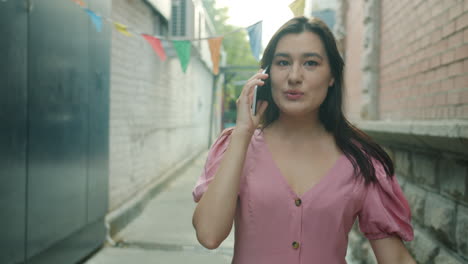 woman talking on mobile phone in an alley