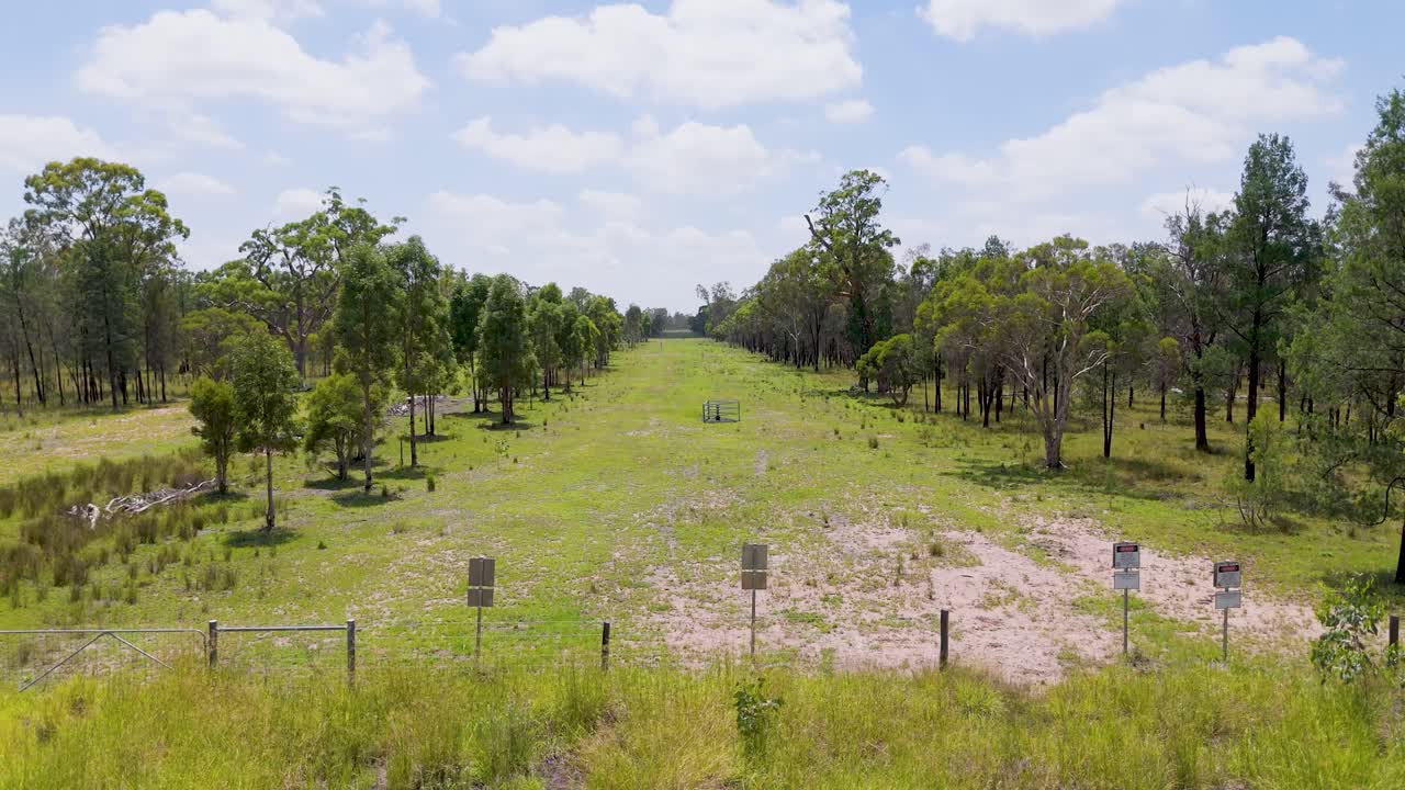 Open Rural Area with Trees and Fence