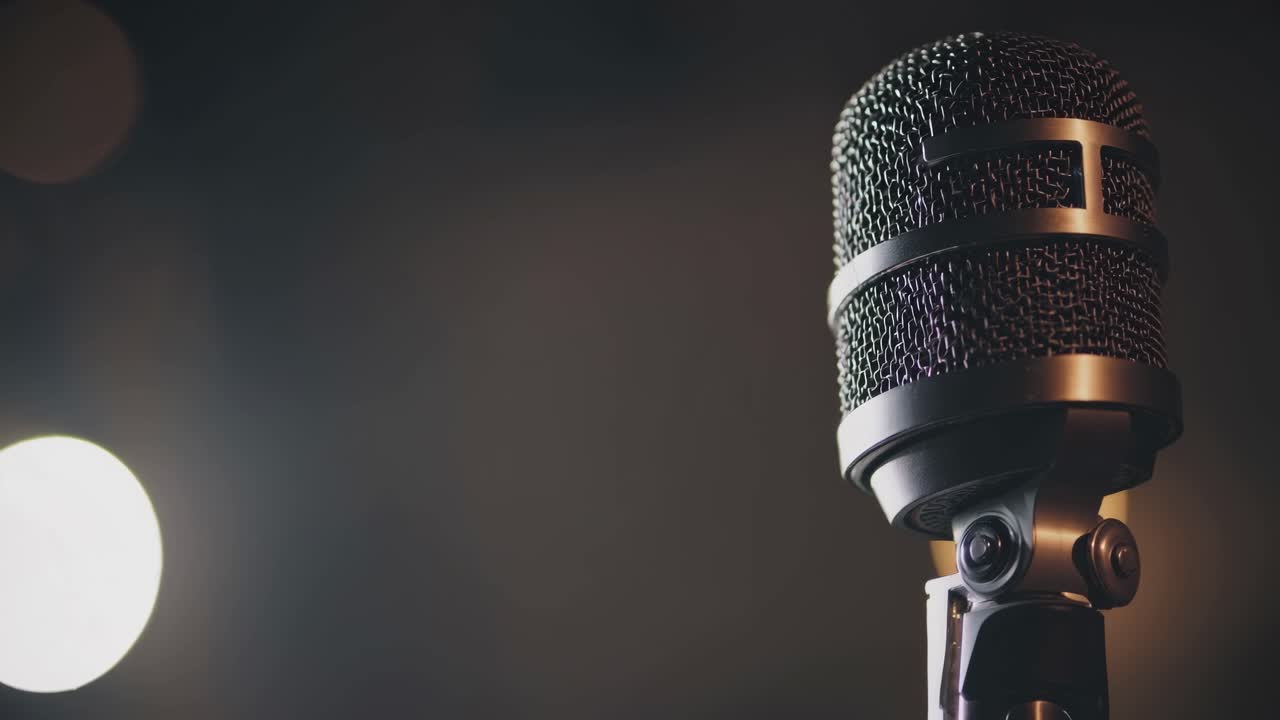 Close-up of a vintage microphone against a blurred bokeh background, captured from a low angle