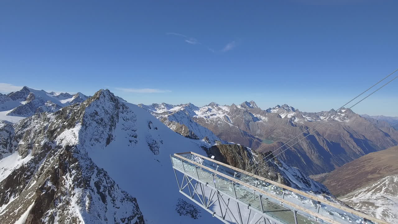 Viewing Platform in Solden Austria, Forward Drone Shot with Snowy Mountains in the Background