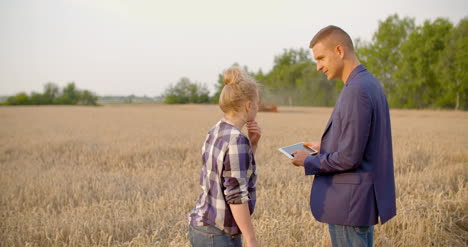 agriculture farmer talking with businessman at harvesting 10