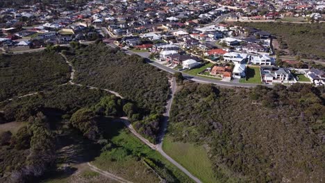 Tilt-Down-View-Showing-Houses-Surrounding-Nature-Reserve-And-Old-Quinns-Rocks-Caravan-Park-Site