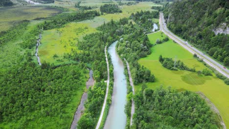 Aerial-of-alpine-mountain-river-and-road-in-Germany,-Garmisch-Partenkirchen-Bavarian-village,-Germany