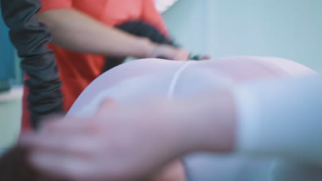 cosmetologist does vacuum massage of client large tummy