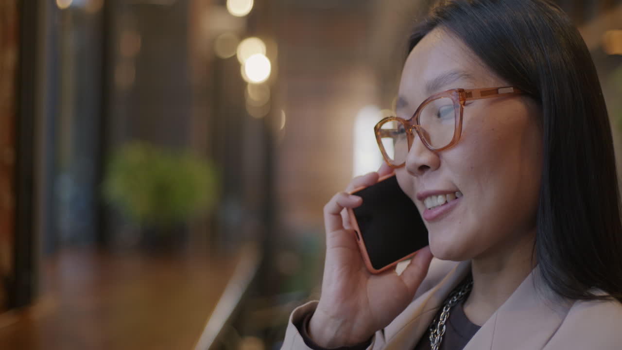 Woman on a Phone Call in a Cafe