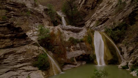 aerial footage of a waterfall in the middle of an arid mountains of puebla méxico