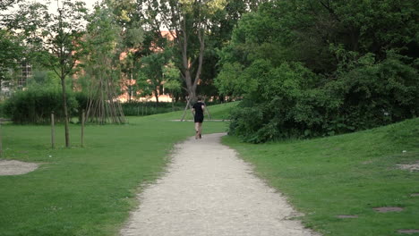 young man running at dirt path in the park