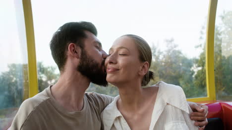 man kissing her happy girlfriend