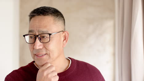 christmas time, smiling senior man wearing glasses and sweater enjoying holiday season at home