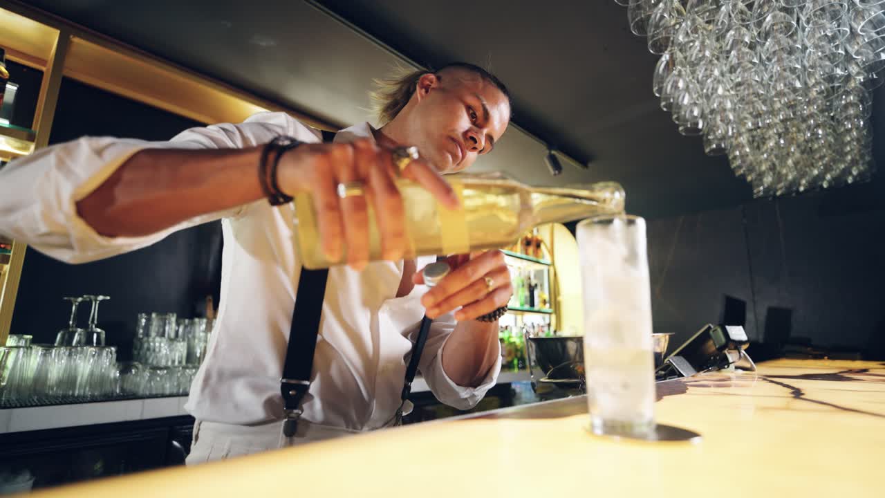 Professional Bartender Pouring a Drink into a Glass at a Modern Bar