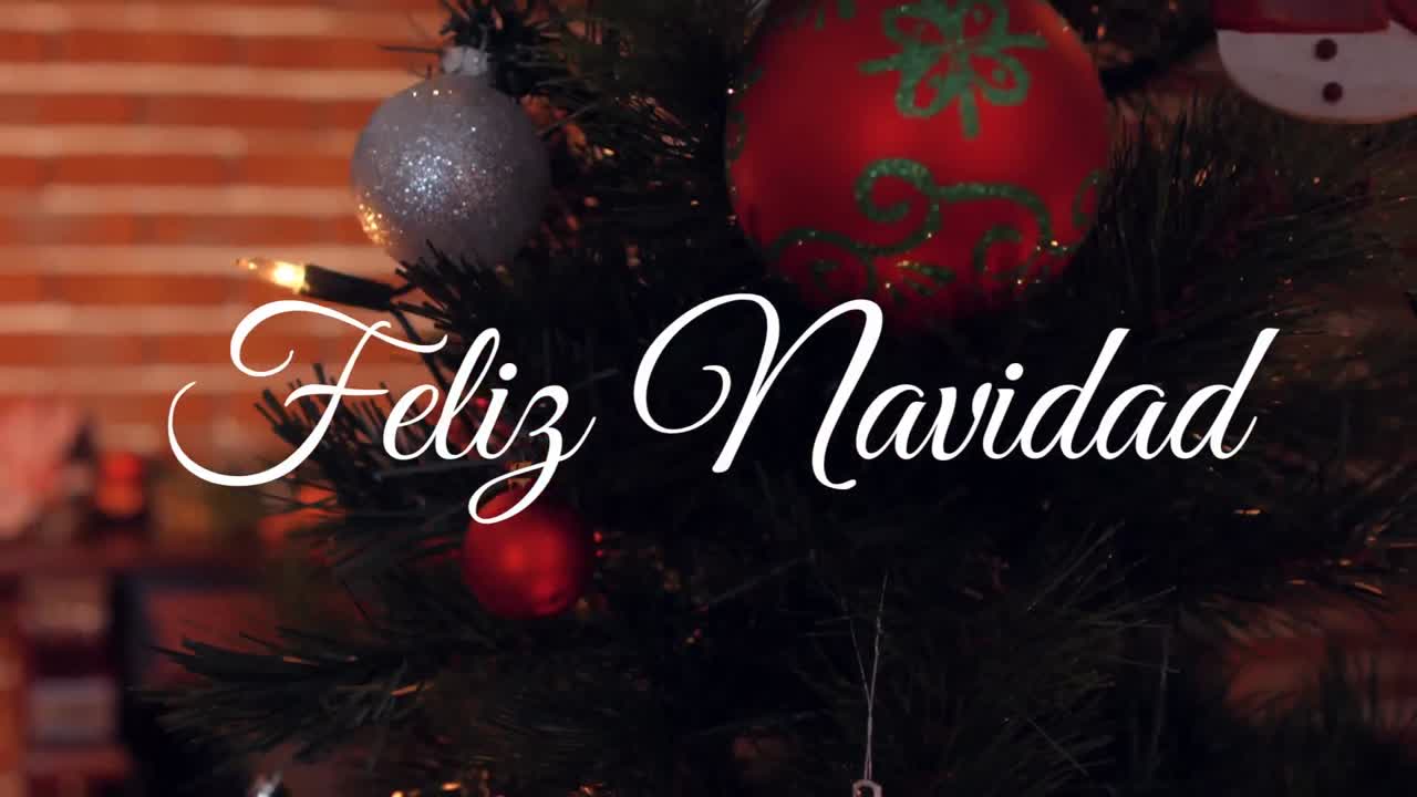 animación de felicitaciones navideñas españolas sobre el árbol de navidad con bolas