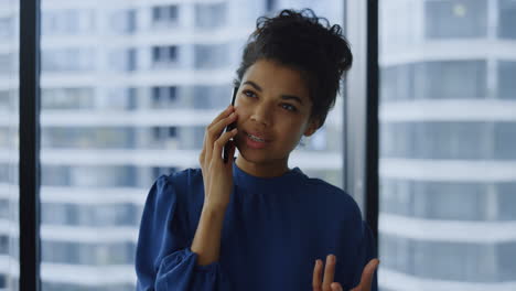 businesswoman calling on mobile phone in office. emotional woman gesturing hand