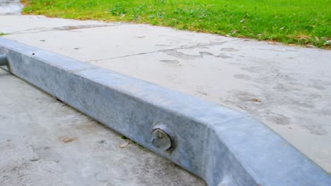 Close-up-of-young-man-practicing-skateboarding-on-ramp-in-skateboard-park-4k