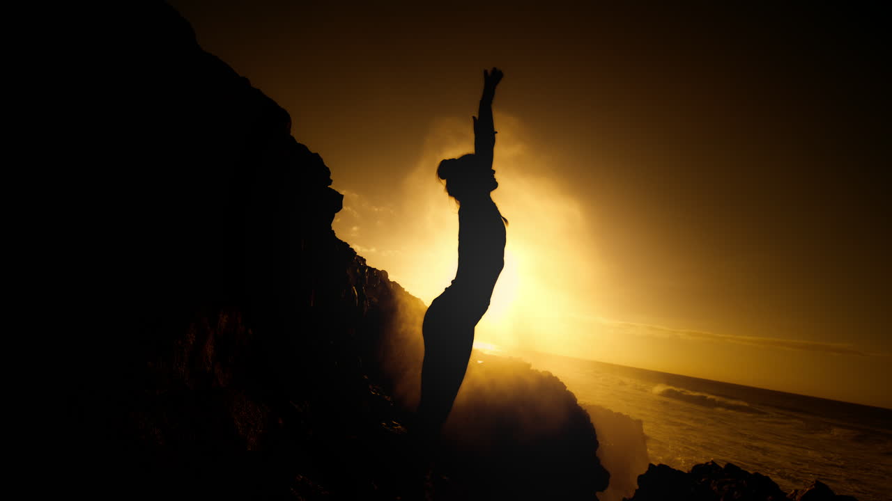 Woman Silhouetted Against a Stunning Sunset Ocean Sunrise
