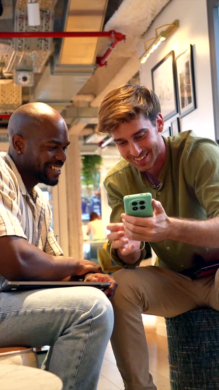 Two Happy Men Taking a Selfie and Laughing in Modern Office