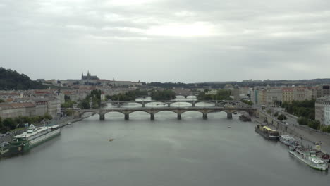 Forward-aerial-of-bridges-over-Vltava-River-and-cityscape-of-Prague