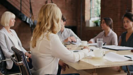 4k video footage of a young businesswoman having a meeting with her colleagues in a modern office