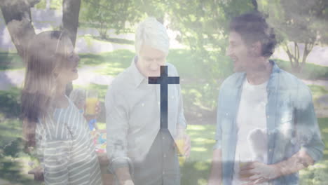 gathering outdoors, people holding drinks with animation of cross symbol overlay