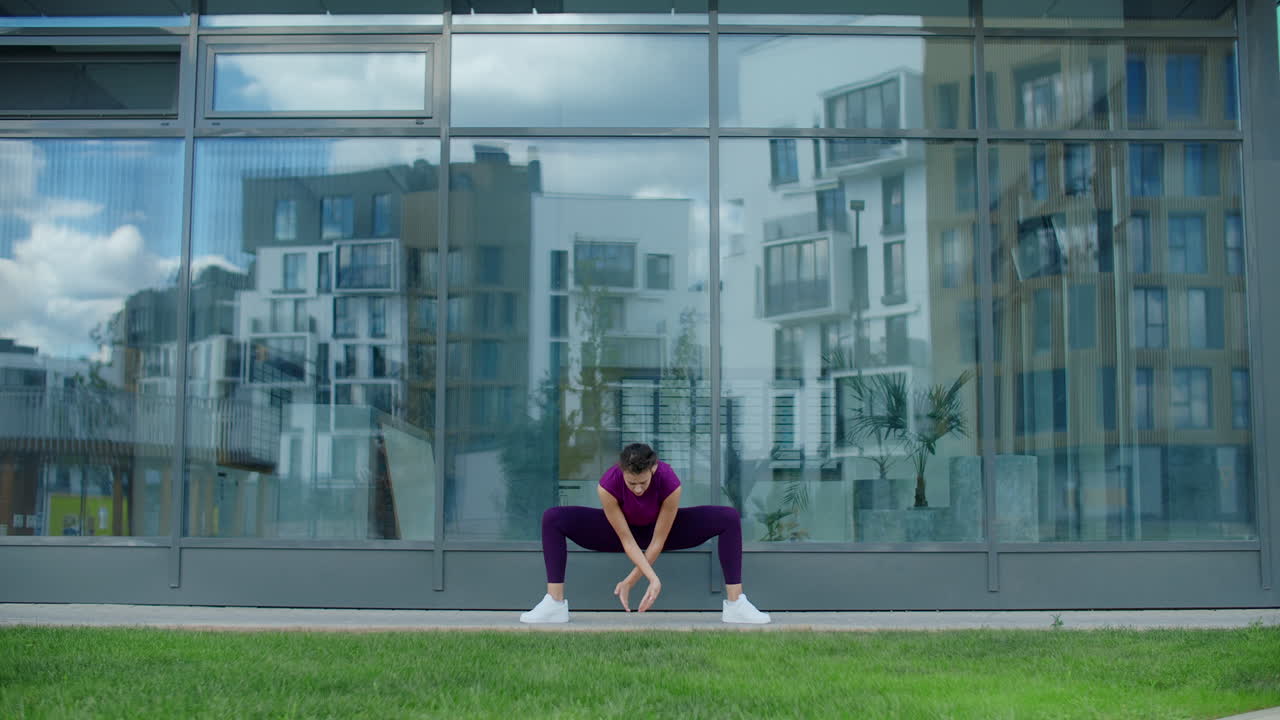 Woman Doing Yoga Outdoors in a City
