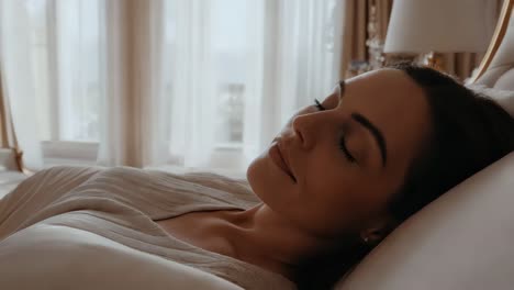 una mujer durmiendo en un lujoso dormitorio.