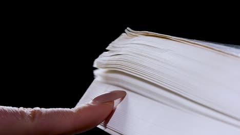 finger on a book page