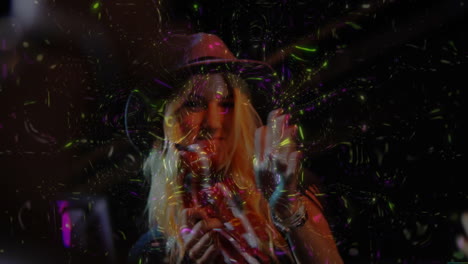 woman singing into microphone in music club, with swirling neon projections dancing across scene