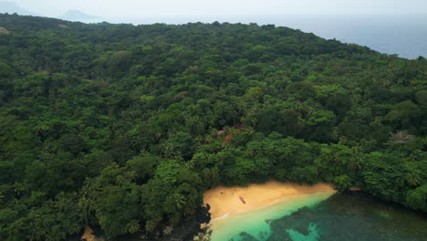 aerial pan shot overlooking the margarida beach and dense jungle of sao tome