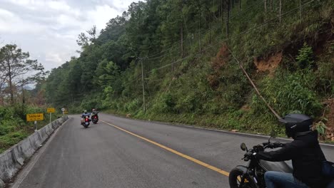 group of motorcyclists cruising on a scenic road