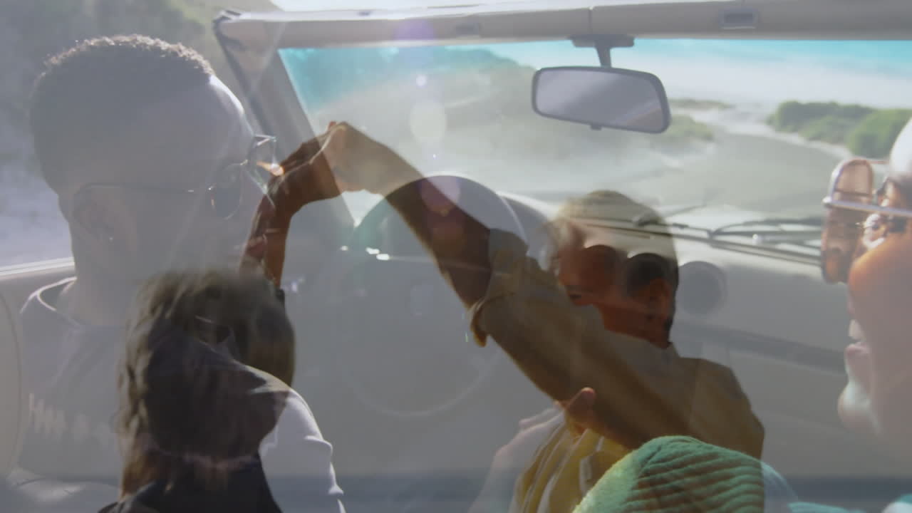 Dancing joyfully, people in animation overlaid on scenic drive in convertible car