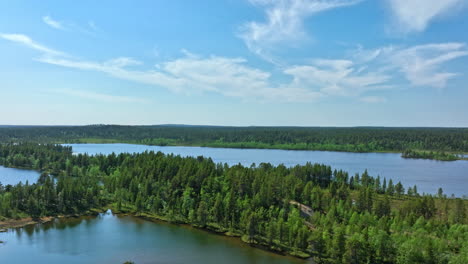 lakes and wetlands in vatsari wilderness, summer in lapland - aerial rising shot