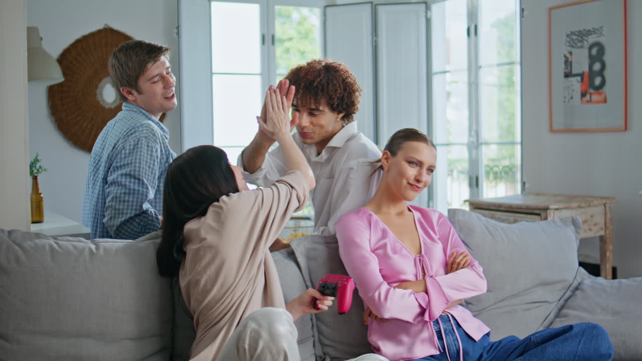 Competitive girls enjoying video game at sofa closeup. Woman winning competition