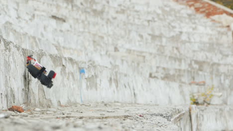 racing drone maneuvers dangerously near a concrete wall