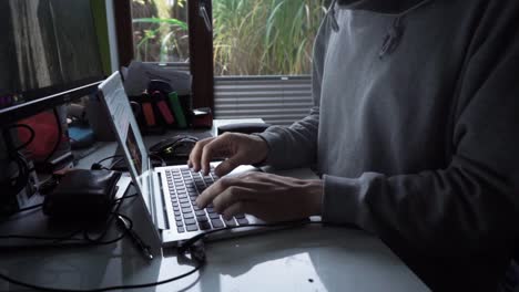 male in home office setting. typing on computer