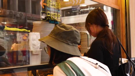 two people selecting treats at a bakery