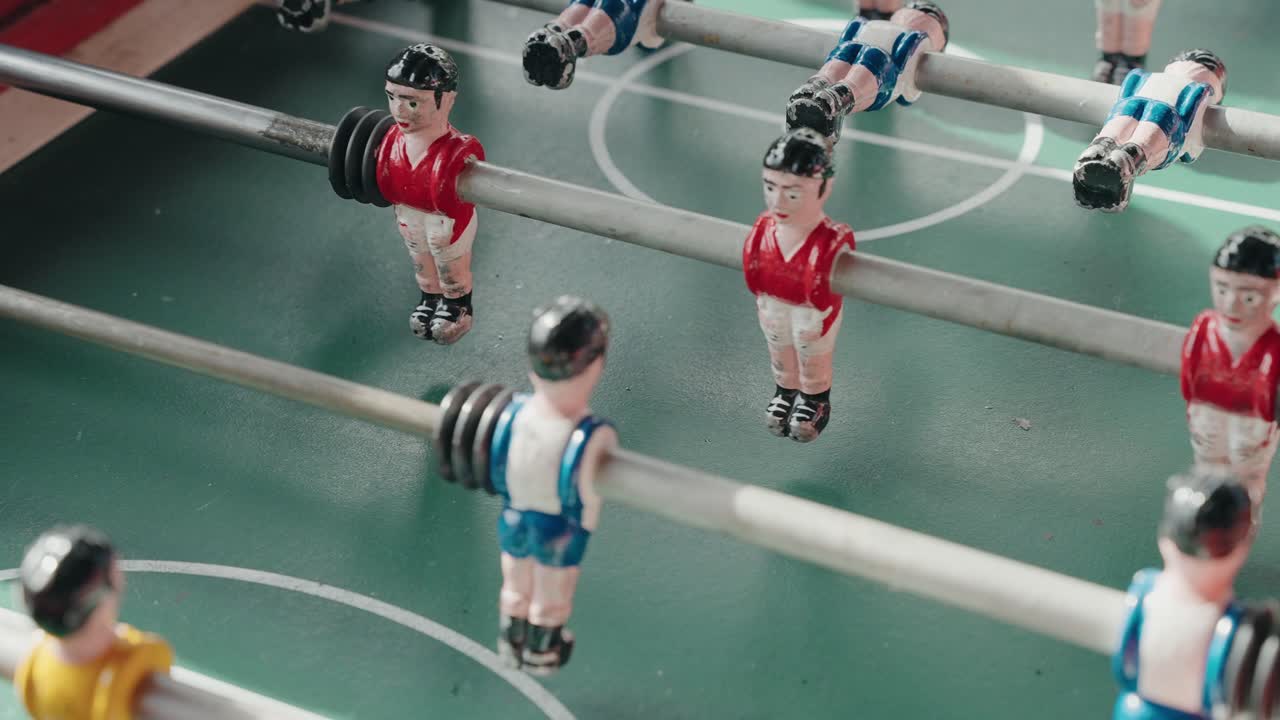 Close up foosball figures spinning quickly during intense tabletop match