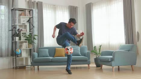 asian man show skill with soccer ball in living room, soccer freestyle