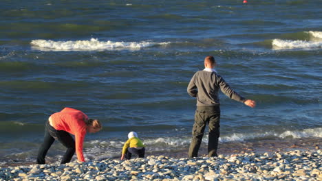 Family of three on pebble beach