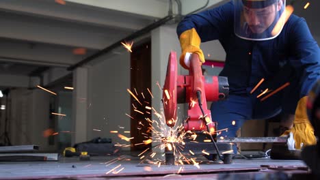 Professional-mechanic-is-cutting-steel-metal.