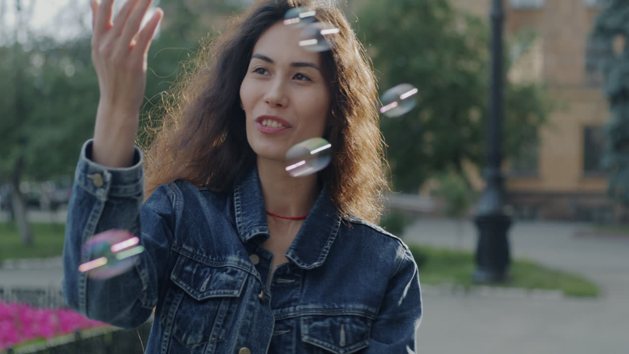 Woman Playing with Bubbles in the City